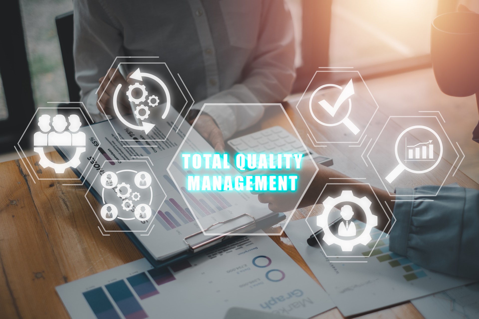 Total quality management concept, Business team analyzing income charts and graphs on office desk with total quality management icon on virtual screen.